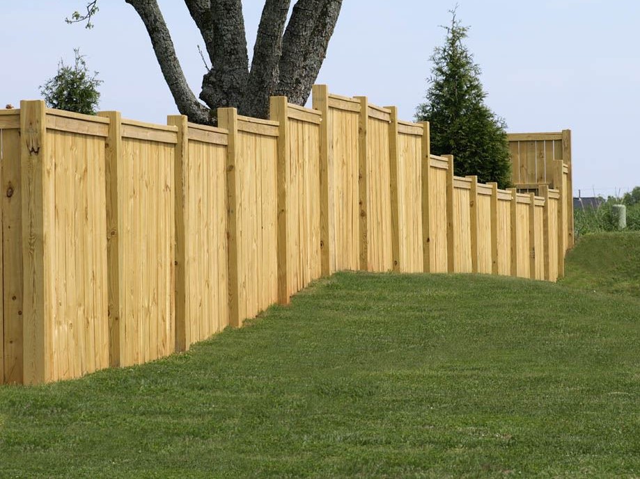 Photo of a tall privacy fence with stair stepped grade
